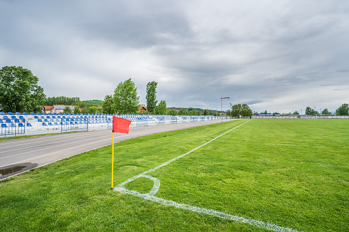 May 13th 2021, Knjazevac - Serbia: Empty grandstand with blue seats with no people on small soccer football stadium in cloudy day