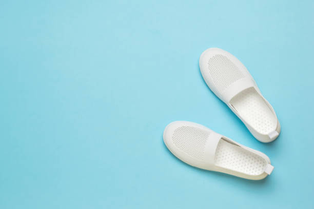 istock White summer women's sneakers on a light blue background. 1318059734