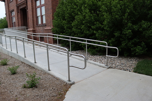 A metal railing alongside a building access ramp