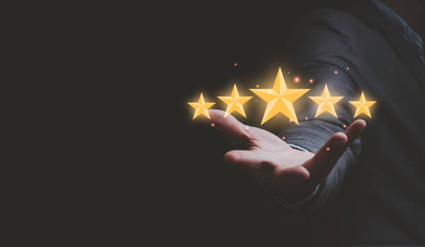 istock Businessman holding virtual five stars for customer feedback rating and evaluation concept. 1318068350