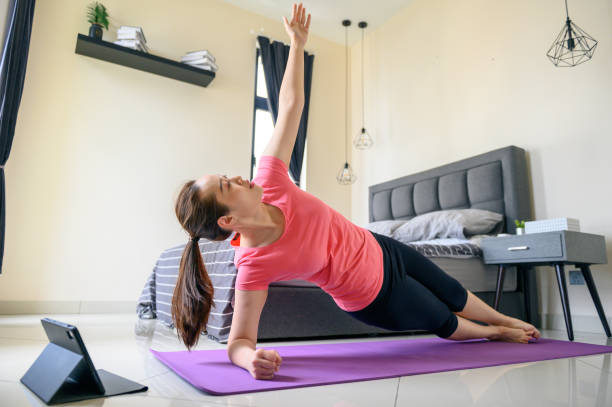 istock Asian woman learning online work out at home 1318069322
