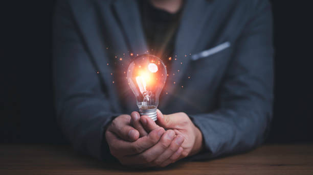 istock Businessman holding connection of light bulb with orange ray , Creative thinking idea and innovation concept. 1318070012