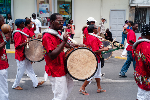 Marigot, Saint Martin - July 14 2013: Parade for Bastille Day or Quatorze Juillet with a Drummer Playing a Bass Drum of an Afro-Caribbean Creole Band.