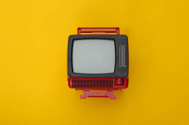 istock Red retro old mini tv set on yellow background. Top view 1318091133