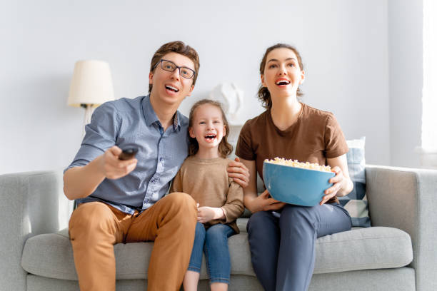 istock family watching TV 1318092228