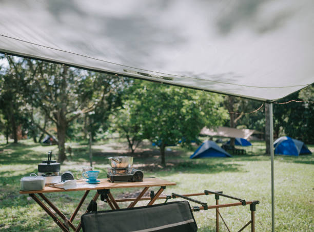 istock camping setup summer with tent, table, chair and cooking utensil 1318093465