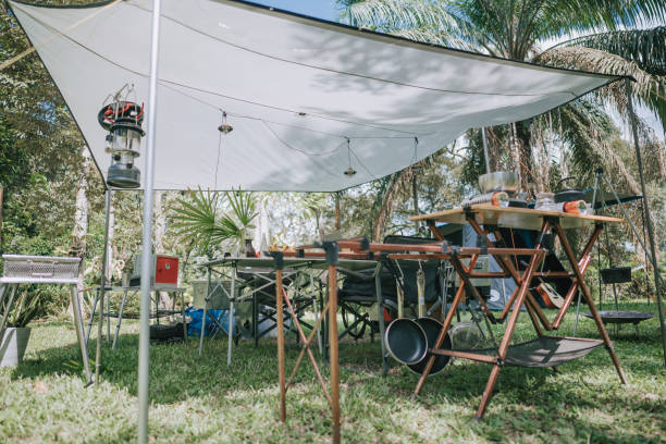 istock camping setup summer with drip coffee, kettle , camping stove, gas can, cooking pot , pot on table 1318093484