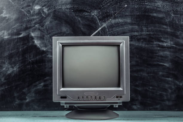 istock Red retro old school portable mini tv set on blackboard background 1318093489