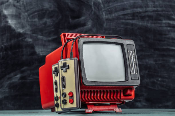 istock Retrogaming. Video game competition. Old TV with gamepads on blackboard background 1318093581