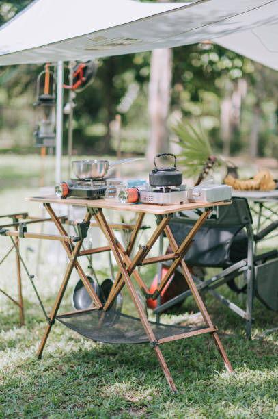 istock camping setup summer with tent, kettle, and camping stove 1318093616