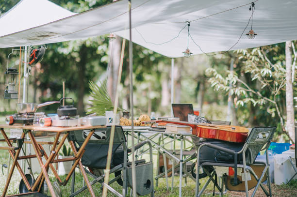 istock camping setup summer with tent, table, chair and cooking utensil 1318093628