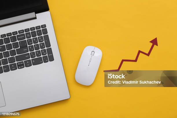 Laptop And Pc Mouse With A Rising Arrow On Yellow Background Online Business Trading Top View Flat Lay Stock Photo - Download Image Now