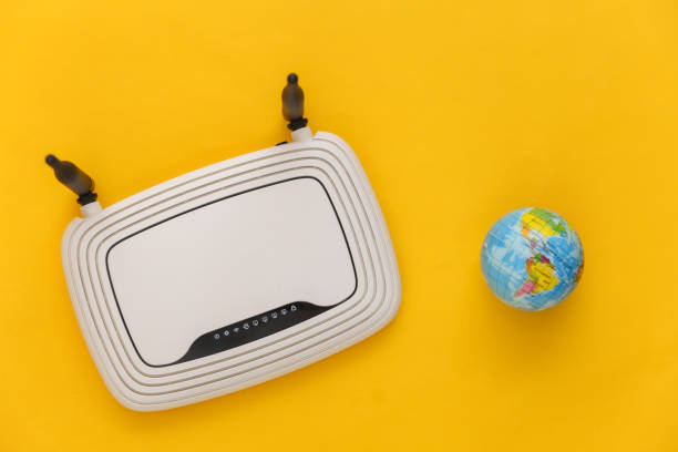 Global network. Wi-Fi router with a globe on yellow background. Top view