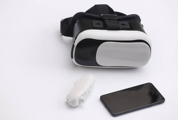 istock Virtual reality headset with joystick and smartphone on white background. Modern gadgets 1318095824