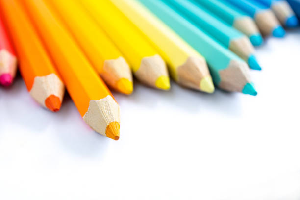 Set of colorful pencils on pink background.