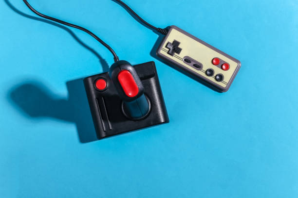 istock Retro joystick and gamepad on blue background with shadow. Retro gaming. Top view 1318097987