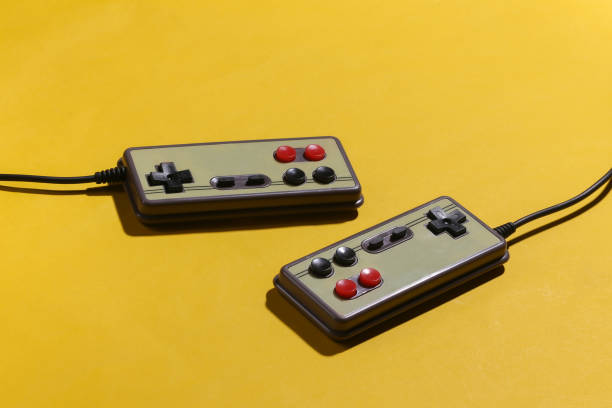 istock Retro gamepads on yellow background with shadow. Retro gaming. 1318098013