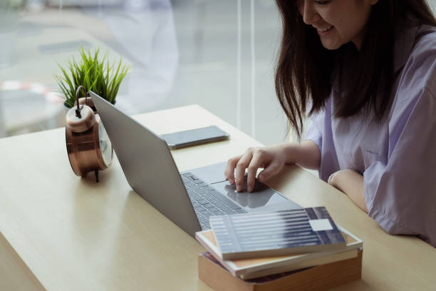 istock Online education. Asian girl online lesson using a computer video call to a virtual teacher at home 1318099171