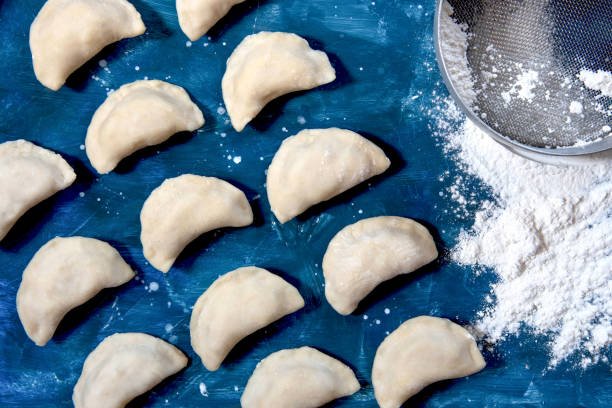 istock Raw dumpling with potatoes. Preparation dumplings on a blue background 1318102725