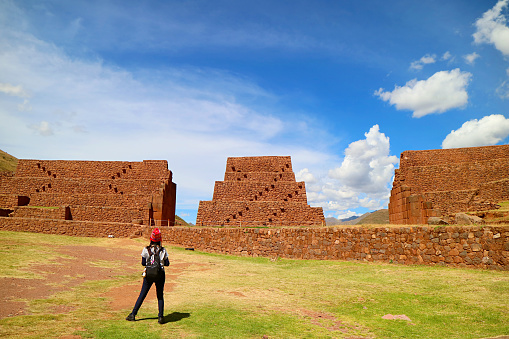 Female Tourist Admiring the Ancient Structures of Rumicolca,  Amazing Archaeological Site of Wari Civilization in Cusco Region, Peru, ( Self Portrait )