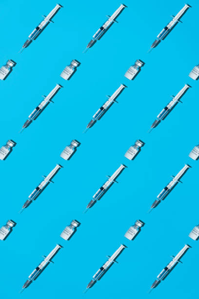 istock Patterm with COVID-19 vaccine on a blue background 1318108126