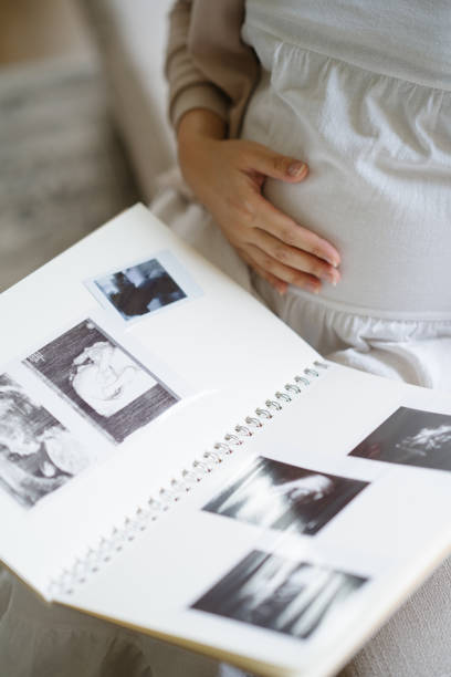 istock Pregnant woman looking at notebook. 1318108387