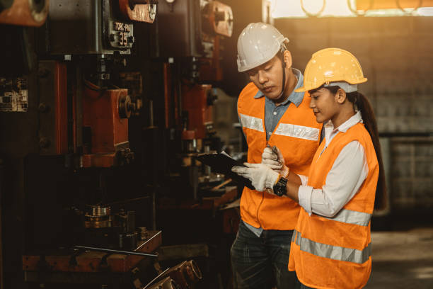 istock Engineer team male working with women work help support together in heavy industry teach and training machine operation in factory 1318109606