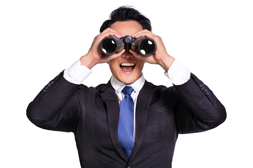 Surprised Young businessman  looking  through binoculars