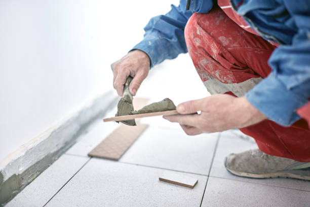 istock Professional ceramics tile man worker placing new tiles on the floor and wall. 1318110997
