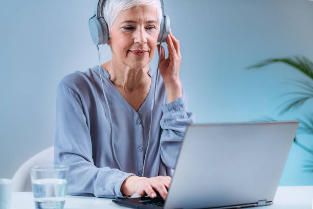 istock Senior Woman Doing Audiogram Hearing Test at Home, using Laptop 1318111112