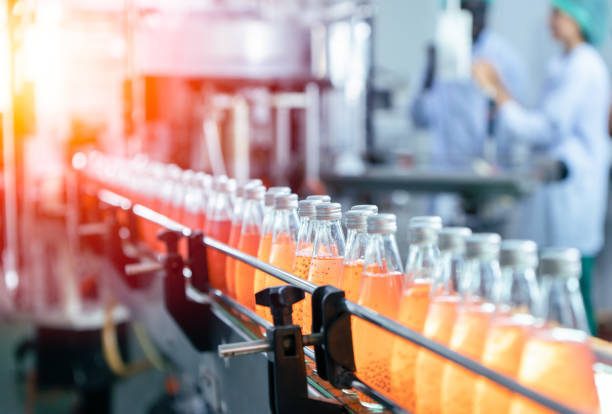 Drink factory production line fruit juice beverage product at conveyor belt. Drink factory production line fruit juice beverage product at conveyor belt. bottling plant stock pictures, royalty-free photos & images