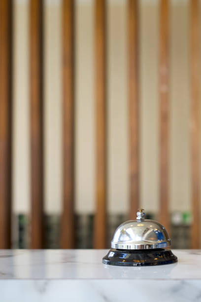 istock Silver service bell on hotel reception desk. Close up 1318111758