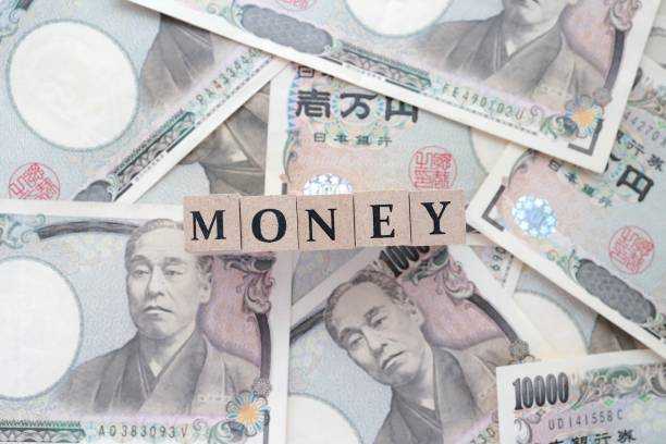 istock 10,000 yen bills and wooden blocks 1318112995