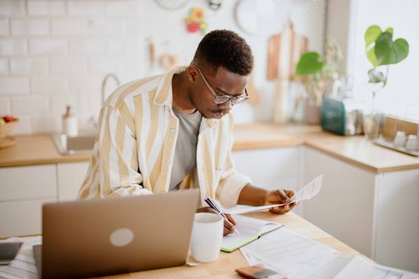 istock Young man uses a laptop to work from home 1318114525