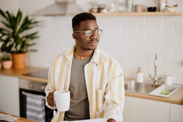istock Young man uses a laptop to work from home 1318114617
