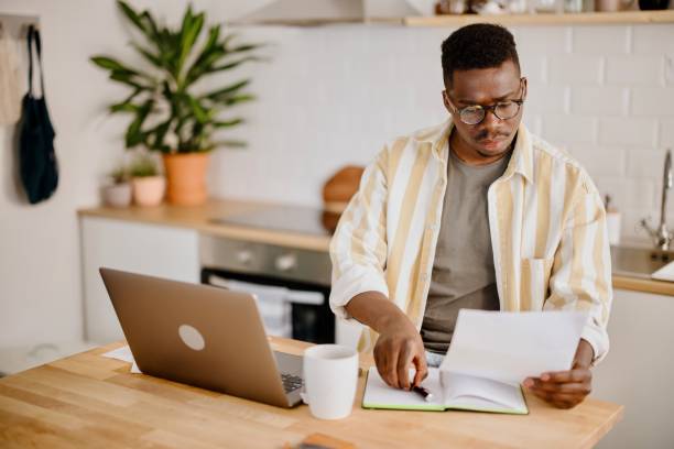 istock Young man uses a laptop to work from home 1318114618