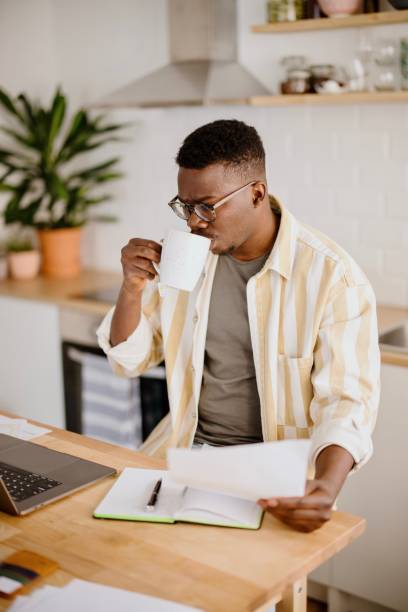 istock Young man uses a laptop to work from home 1318114622