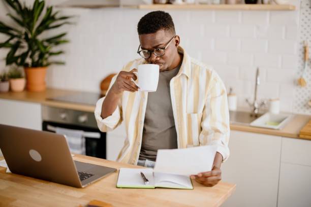 istock Young man uses a laptop to work from home 1318114634