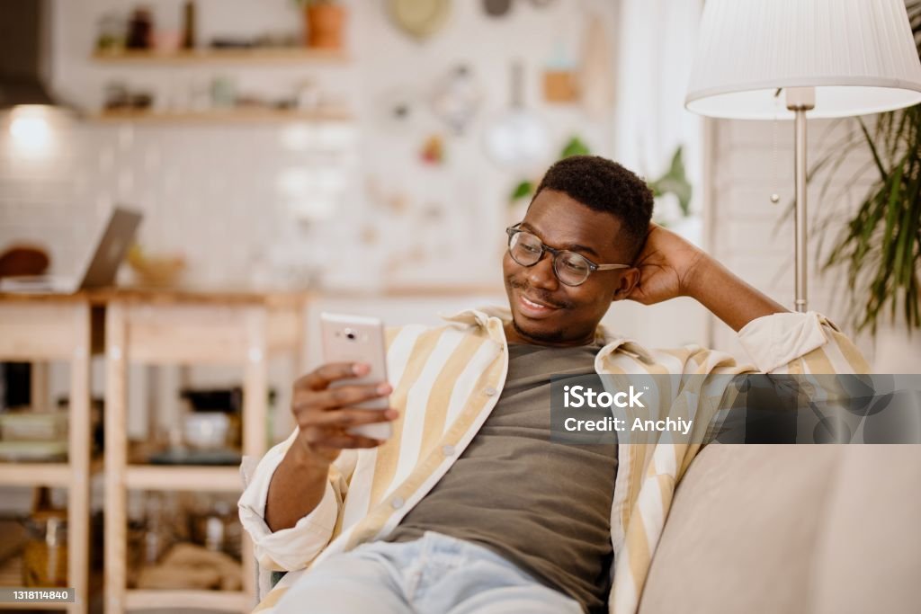 Young Man Relaxing At Home Watching Funny Videos And Photos Online Stock  Photo - Download Image Now - iStock