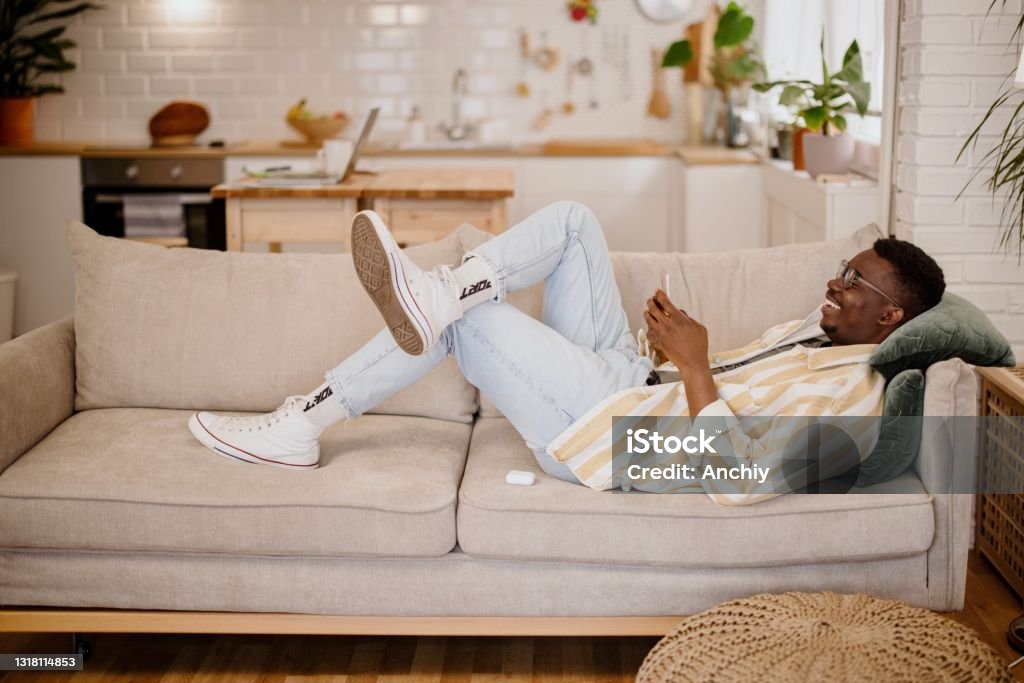 Young Man Relaxing At Home Watching Funny Videos And Photos Online Stock Photo - Download Image Now - iStock Young Man Relaxing At Home Watching Funny Videos And Photos Online Stock Photo - Download Image Now - iStock