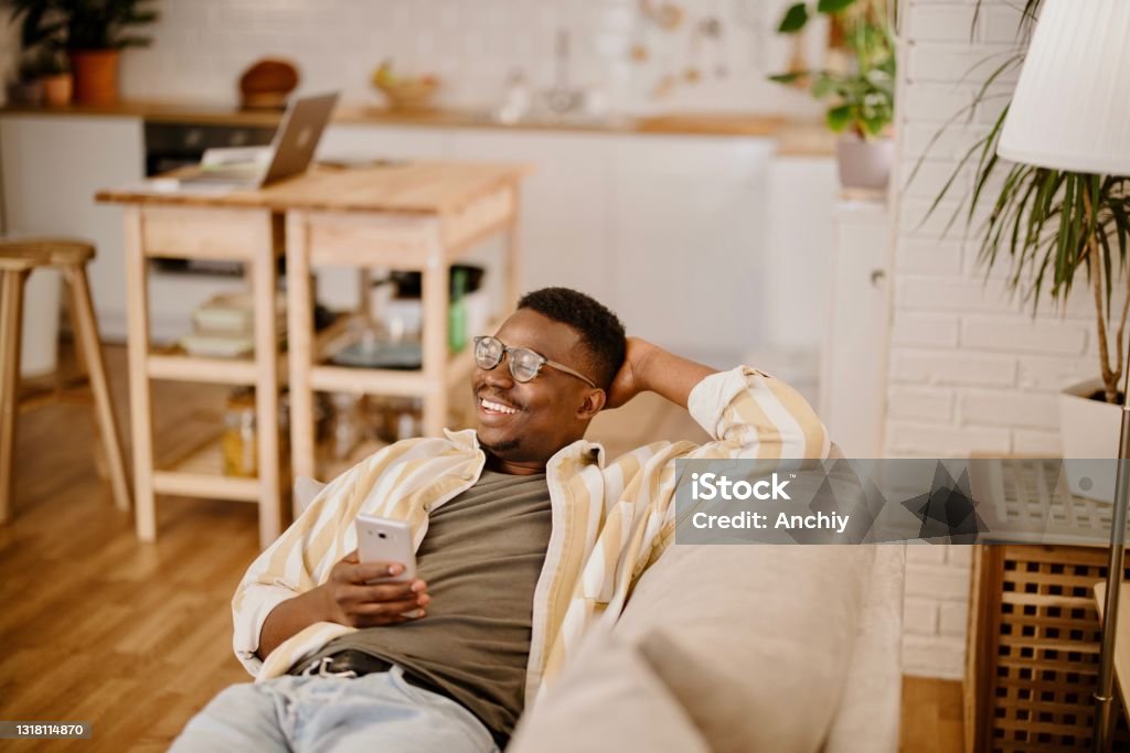 Young Man Relaxing At Home Watching Funny Videos And Photos Online Stock  Photo - Download Image Now - iStock