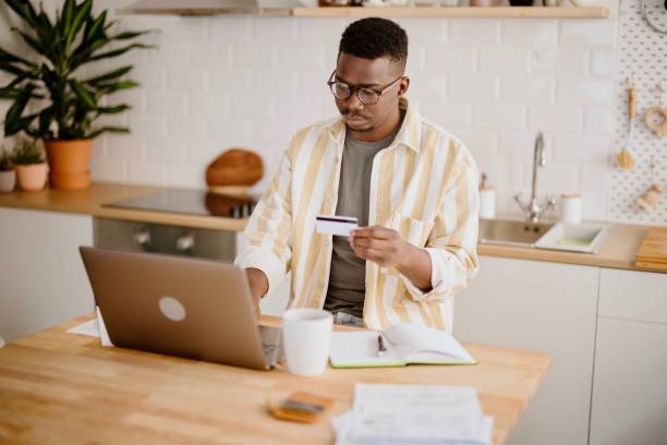 istock Young man uses credit card to buy cryptocurrency 1318115570