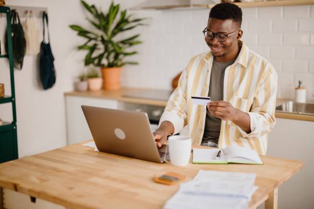 istock Young man uses credit card to buy cryptocurrency 1318115572