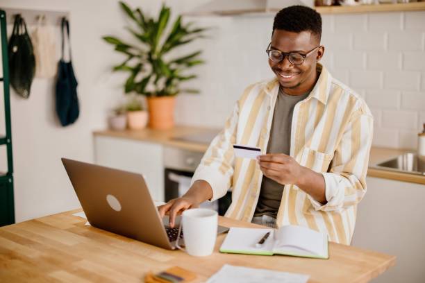 istock Young man uses credit card to buy cryptocurrency 1318115587
