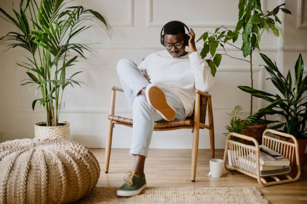 istock Young man listens to music while scrolls social media 1318116493