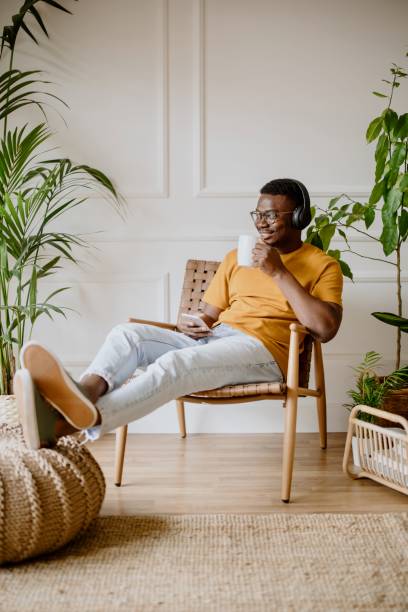 istock Young man listens to music while scrolls social media 1318116496