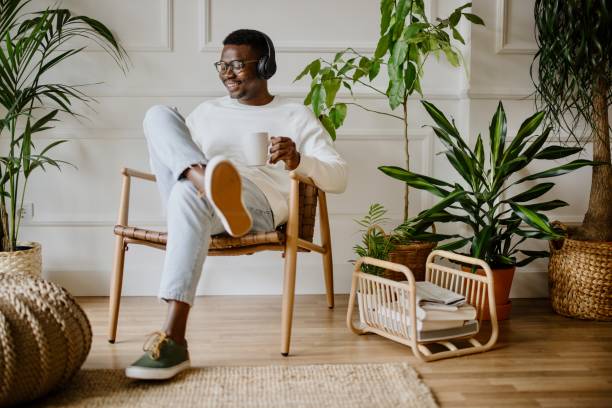 istock Young man listens to music while scrolls social media 1318116500