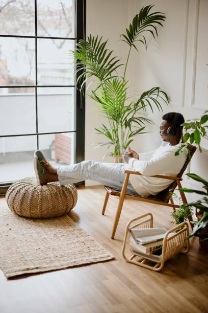 istock Young man listens to music while scrolls social media 1318116505