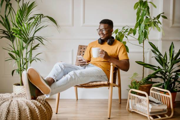 istock Young man relaxing at home while scrolls social media 1318116524
