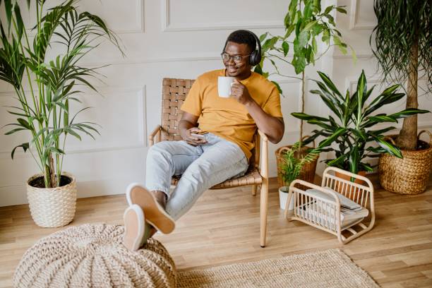istock Young man listens to music while scrolls social media 1318116537